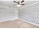 Spacious bedroom with wall accent, ceiling fan, closet, and window at 4221 3Rd W Ave, Palmetto, FL 34221