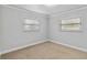 Neutral bedroom featuring two windows and neutral carpet at 4221 3Rd W Ave, Palmetto, FL 34221