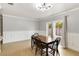 Light-filled dining room with a wooden table and a view of the backyard through sliding glass doors at 4221 3Rd W Ave, Palmetto, FL 34221