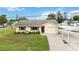 Charming single story home with a tan exterior, well-maintained lawn, and a carport for covered parking at 4221 3Rd W Ave, Palmetto, FL 34221