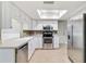 Well-lit kitchen with white cabinets, stainless steel appliances, and a skylight for ample natural light at 4221 3Rd W Ave, Palmetto, FL 34221