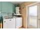 Bright laundry room with washing machine, dryer, and water heater at 4221 3Rd W Ave, Palmetto, FL 34221