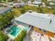 An aerial view of a charming home with a pool and spa surrounded by lush landscaping at 424 62Nd St, Holmes Beach, FL 34217