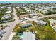 Aerial shot of the home near a street with other homes, businesses, and mature landscaping at 424 62Nd St, Holmes Beach, FL 34217