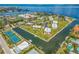 Panoramic aerial view highlighting the waterfront community with boat docks and amenities like tennis courts and a pool at 424 62Nd St, Holmes Beach, FL 34217