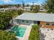 Aerial view showcases pool, patio, landscaped yard, and the exterior of the home at 424 62Nd St, Holmes Beach, FL 34217