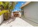 Landscaped backyard with lush greenery, a deck, and outdoor dining area at 424 62Nd St, Holmes Beach, FL 34217