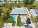Aerial view of backyard with pool, lush landscaping, and ample parking, creating a private retreat at 424 62Nd St, Holmes Beach, FL 34217