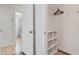 A bedroom closet showing shelving and a rod. Bathroom visible in the background at 424 62Nd St, Holmes Beach, FL 34217