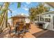 Inviting deck area with outdoor dining table, grill, and bamboo bar at 424 62Nd St, Holmes Beach, FL 34217