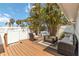 Outdoor deck area with stylish seating, tropical landscaping, and a grill at 424 62Nd St, Holmes Beach, FL 34217