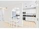 Bright kitchen featuring white cabinets, breakfast bar, and stainless steel appliances at 424 62Nd St, Holmes Beach, FL 34217