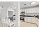 Bright kitchen featuring white cabinets, breakfast bar, and stainless steel appliances at 424 62Nd St, Holmes Beach, FL 34217