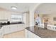 Bright kitchen featuring white cabinets, granite countertops, and an island with seating at 424 62Nd St, Holmes Beach, FL 34217