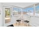 Bright sun room nook with two chairs and a table with an exterior door at 424 62Nd St, Holmes Beach, FL 34217