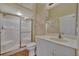 Bathroom featuring a tiled floor, a vanity with sink, toilet, and a shower with glass door at 4344 Nizza Ct, Venice, FL 34293