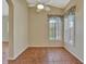 Bright bedroom with tile flooring and shuttered windows offering natural light, complemented by a ceiling fan at 4344 Nizza Ct, Venice, FL 34293