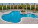 Resort-style community pool area with ample seating, lush landscaping, and tropical palm trees at 4344 Nizza Ct, Venice, FL 34293