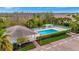 Overhead view of a community pool area with a cabana, lounge chairs and lush foliage at 4344 Nizza Ct, Venice, FL 34293