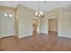 Open dining area featuring tile floors, a decorative chandelier, and seamless access to the kitchen at 4344 Nizza Ct, Venice, FL 34293