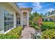 Charming front entrance with a brick walkway surrounded by lush landscaping at 4344 Nizza Ct, Venice, FL 34293