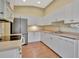 Bright kitchen with white cabinetry, stainless appliances, and tile floors, designed for functionality and style at 4344 Nizza Ct, Venice, FL 34293