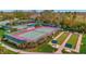 Aerial view of the community tennis and bocce ball courts amidst landscaped grounds at 4344 Nizza Ct, Venice, FL 34293