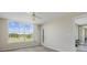 Sunlit bedroom offering golf course views and access to outdoor balcony at 4440 Fairways Blvd # 210, Bradenton, FL 34209