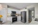 Bright kitchen featuring stainless steel appliances, white cabinetry, and neutral countertops and flooring at 4440 Fairways Blvd # 210, Bradenton, FL 34209