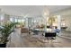 Bright and airy living room featuring contemporary furniture, mirrored wall, and golf course views at 4440 Fairways Blvd # 210, Bradenton, FL 34209