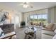 Inviting living room with modern decor, neutral tones, and a view of the golf course through sliding glass doors at 4440 Fairways Blvd # 210, Bradenton, FL 34209