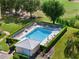 A beautiful community pool surrounded by a manicured hedge and a tranquil green space at 4440 Fairways Blvd # 210, Bradenton, FL 34209