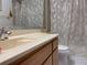 Bathroom featuring a single sink vanity, large mirror, and walk-in shower with decorative curtain at 4944 Village Gardens Dr # 151, Sarasota, FL 34234