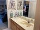Bathroom featuring a single sink vanity, large mirror, and neutral tones at 4944 Village Gardens Dr # 151, Sarasota, FL 34234