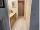 Bathroom featuring a single sink vanity, large mirror, and walk-in shower at 4944 Village Gardens Dr # 151, Sarasota, FL 34234