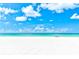 White sandy beach with clear turquoise water and blue skies at 4944 Village Gardens Dr # 151, Sarasota, FL 34234