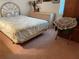Cozy bedroom with light pink carpet, a bed with floral linens, and classic furnishings at 4944 Village Gardens Dr # 151, Sarasota, FL 34234