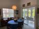 Dining room showcasing a round table with seating and sliding doors to the outdoor patio at 4944 Village Gardens Dr # 151, Sarasota, FL 34234