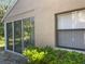 Exterior of home with lanai access and lush greenery at 4944 Village Gardens Dr # 151, Sarasota, FL 34234
