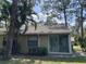 Home exterior with lanai, well maintained lawn, and large shade trees at 4944 Village Gardens Dr # 151, Sarasota, FL 34234