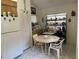 Eat-in kitchen with white appliances, tile flooring, breakfast nook, and plenty of storage at 4944 Village Gardens Dr # 151, Sarasota, FL 34234