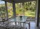 Enclosed lanai area with outdoor seating and views of lush landscaping at 4944 Village Gardens Dr # 151, Sarasota, FL 34234