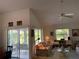 Bright living room featuring a ceiling fan, comfortable seating, and sliding glass doors leading to the outdoors at 4944 Village Gardens Dr # 151, Sarasota, FL 34234