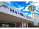 Marina Jack's facade featuring stylish architecture and palm trees against a blue sky at 4944 Village Gardens Dr # 151, Sarasota, FL 34234