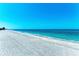 Expansive beachfront view with white sand, calm waves and crystal clear turquoise blue water at 5055 Gulf Of Mexico Dr # 422, Longboat Key, FL 34228
