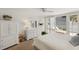 Bright bedroom with white furnishings and access to a private balcony at 5055 Gulf Of Mexico Dr # 422, Longboat Key, FL 34228