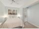 Cozy bedroom with a comfortable bed, soft lighting, a modern art piece and shuttered window at 5055 Gulf Of Mexico Dr # 422, Longboat Key, FL 34228