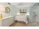 Cozy bedroom features a queen bed, dresser, and a round mirror creating a serene and inviting space at 5055 Gulf Of Mexico Dr # 422, Longboat Key, FL 34228