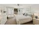 Bright bedroom with white furnishings and access to a private balcony at 5055 Gulf Of Mexico Dr # 422, Longboat Key, FL 34228