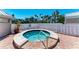 Relaxing community hot tub surrounded by a privacy fence and neat landscaping at 5055 Gulf Of Mexico Dr # 422, Longboat Key, FL 34228